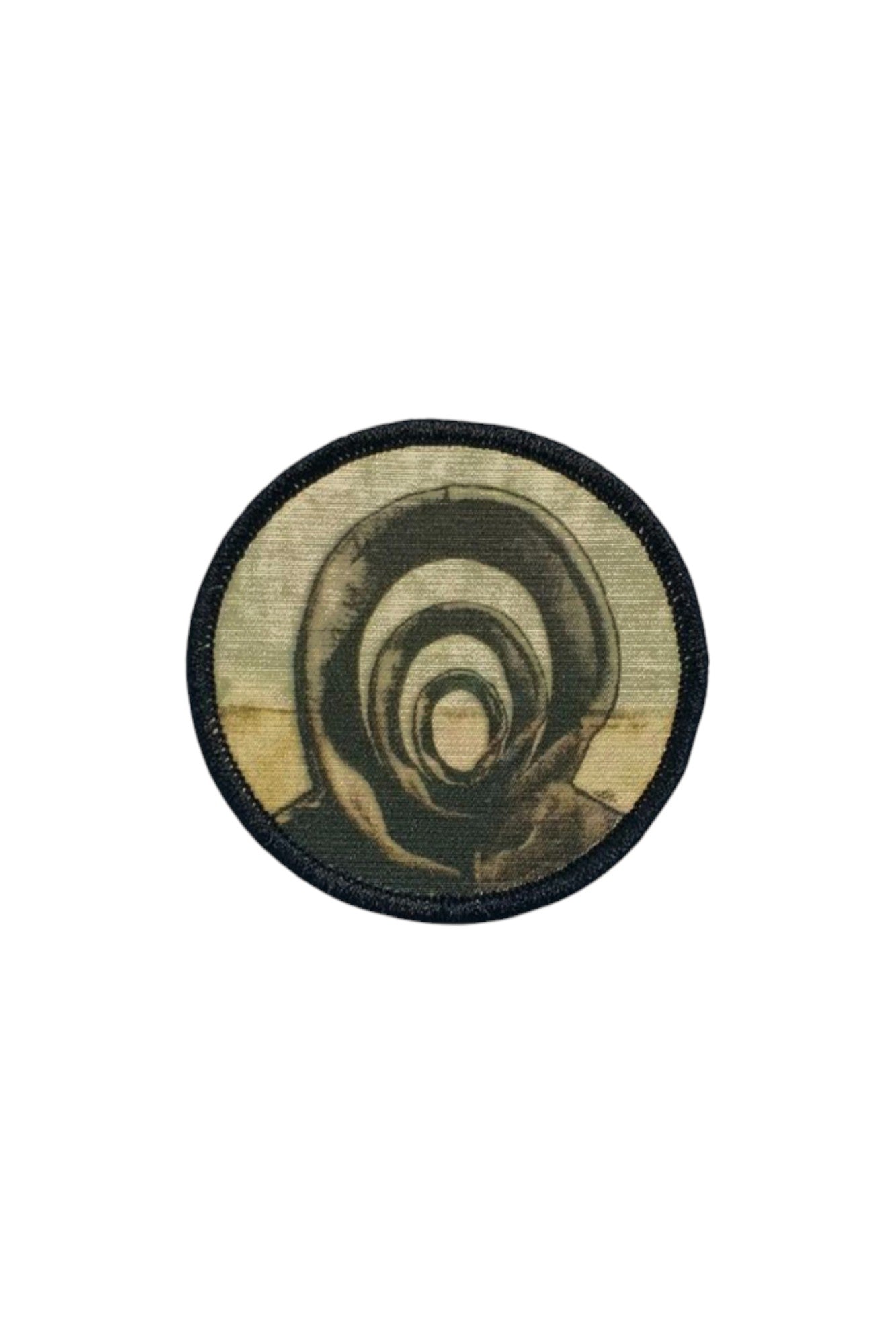 Circular sublimated Patch & Wear™ accessory featuring "Those In-Between" by Candace Hunter; artistic depiction of layered silhouettes in muted tones with a black merrowed edge.