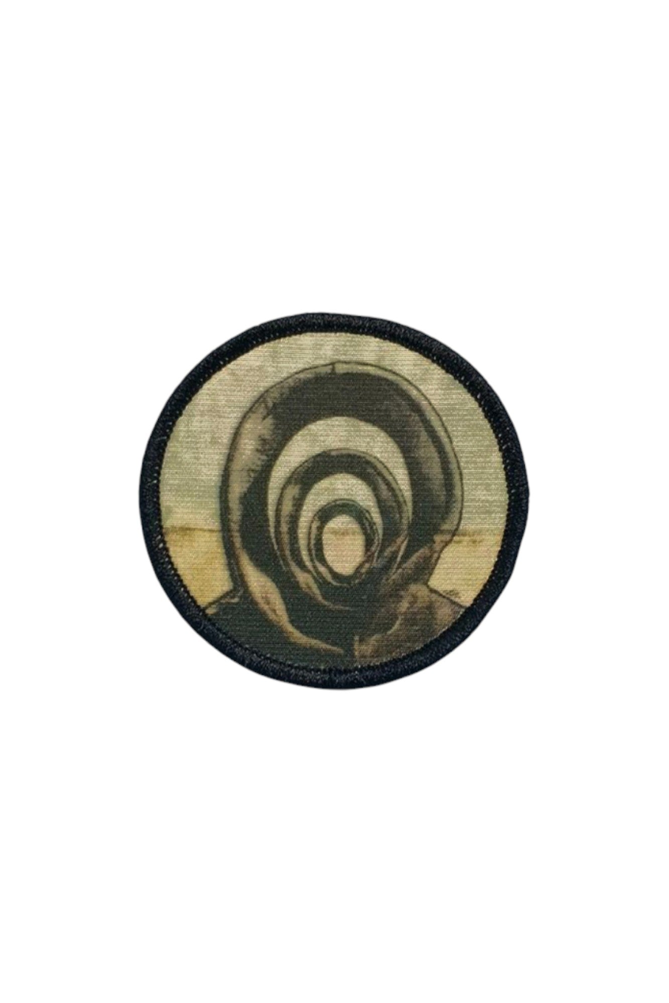 Circular sublimated Patch & Wear™ accessory featuring "Those In-Between" by Candace Hunter; artistic depiction of layered silhouettes in muted tones with a black merrowed edge.