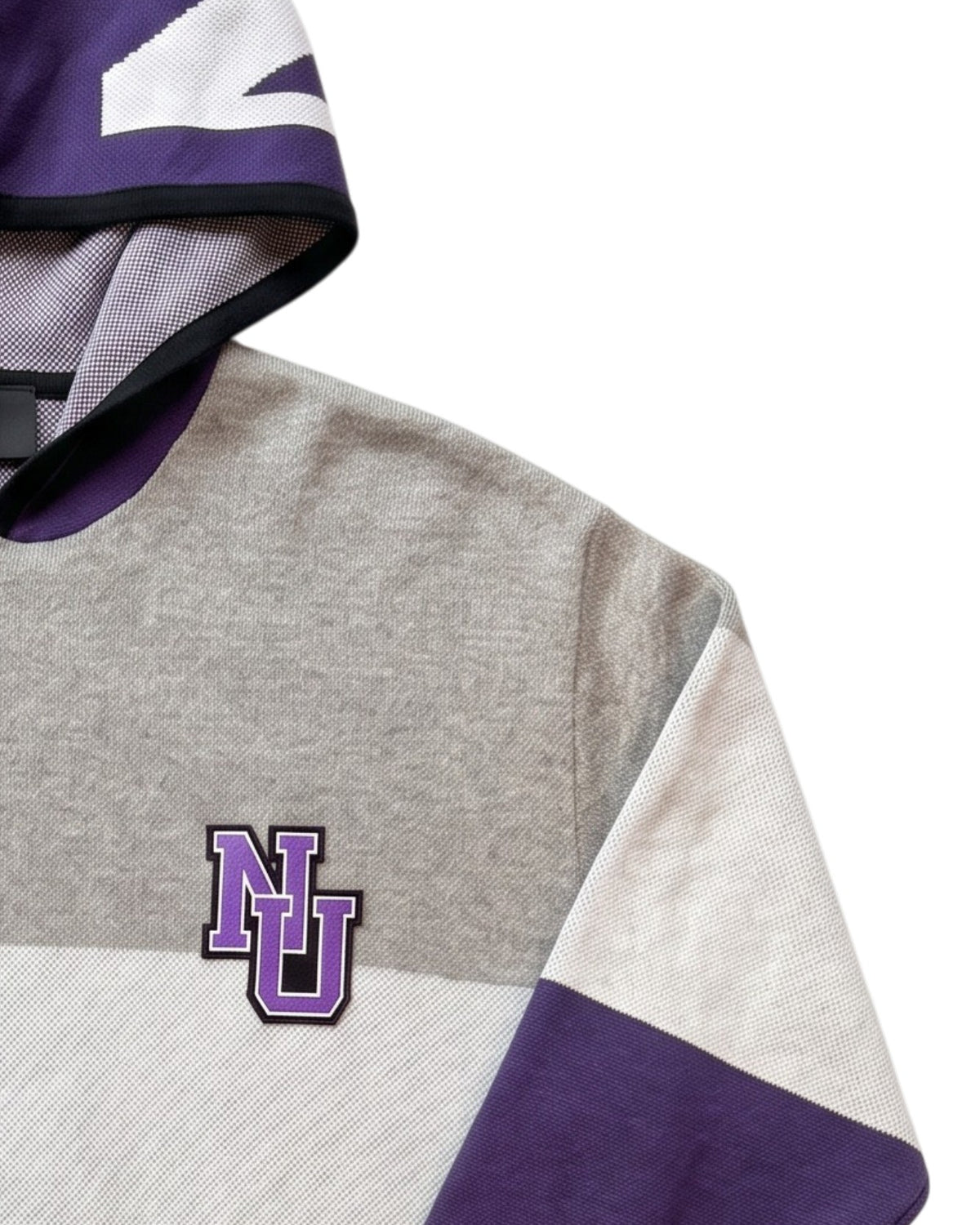 Close up detail of "NU" interlock embroidered crest patch sewn onto Northwestern University purple, white, and light grey striped hooded knit sweater.