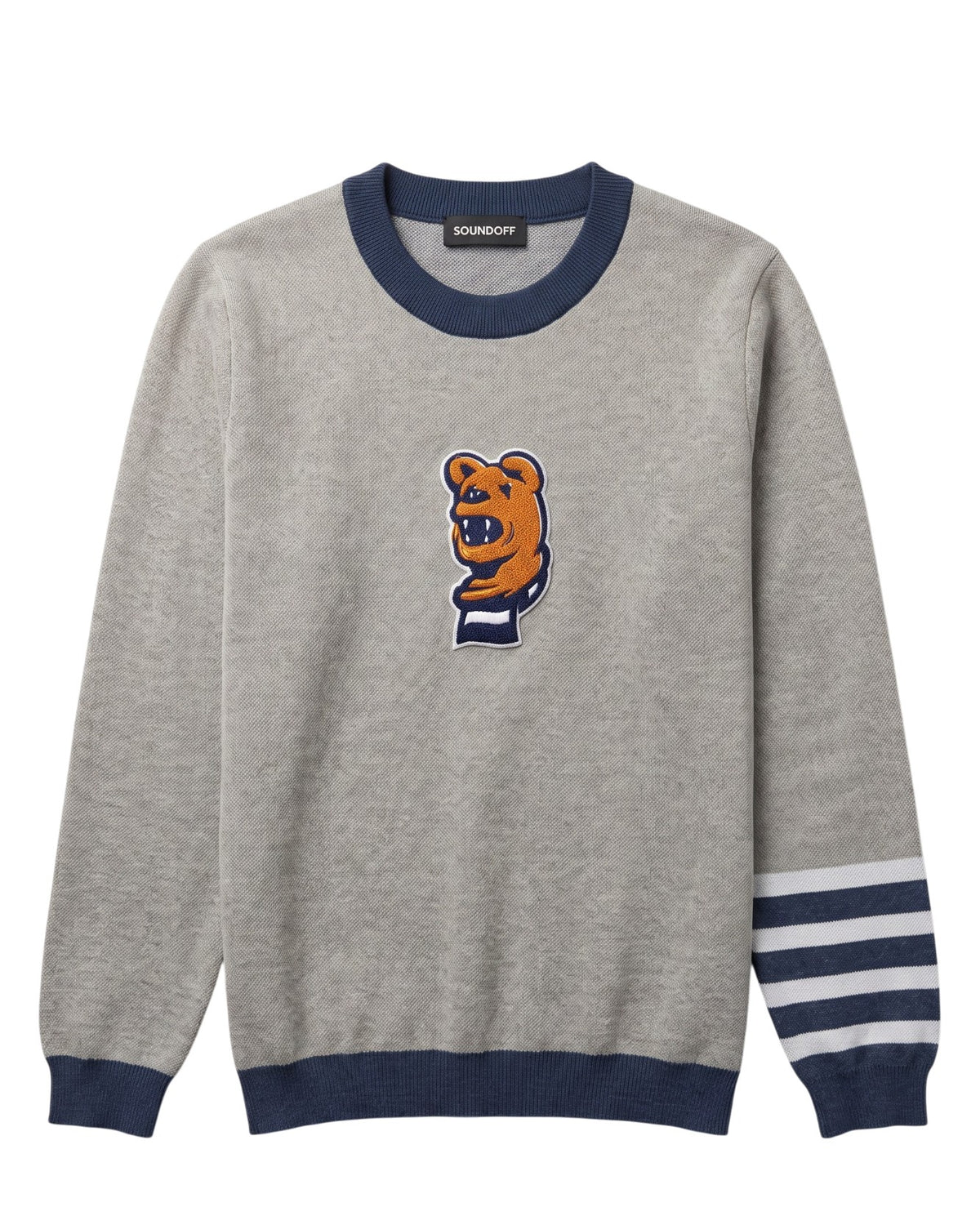Penn State Nittany Lion head chenille varsity patch with scarf in brown, navy and white sewn onto center front chest of light grey classic crewneck knit sweater with navy trim and navy and white stripe detail on left sleeve.