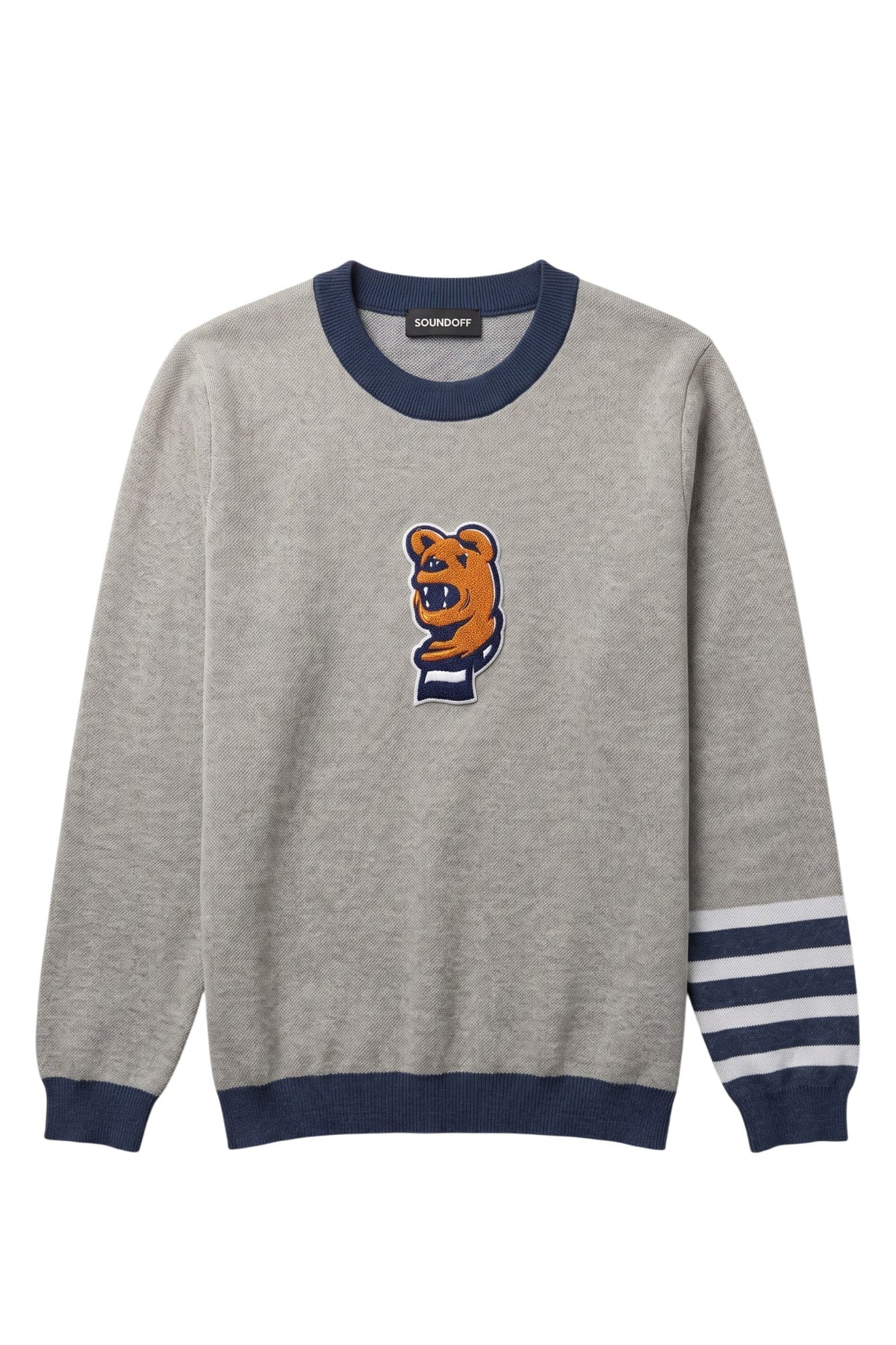 Penn State Nittany Lion head chenille varsity patch with scarf in brown, navy and white sewn onto center front chest of light grey classic crewneck knit sweater with navy trim and navy and white stripe detail on left sleeve.