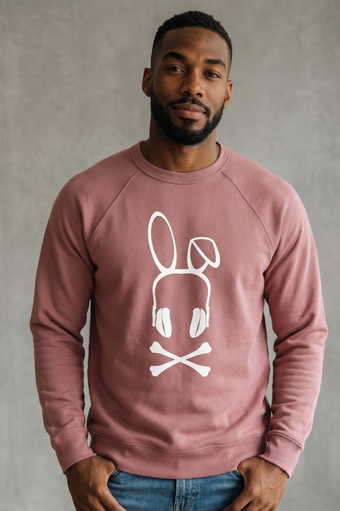 On-body fit view of the Mauve Bad Bunny Headphones Raglan Crewneck Sweatshirt, demonstrating the classic silhouette, raglan sleeve construction, and ribbed cuffs.