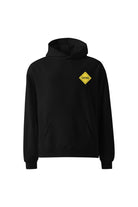 Black hoodie with a yellow caution sign patch on a white background