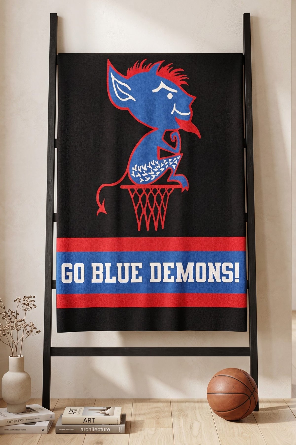 DePaul University varsity knit throw blanket  hanging on blanket rack in black, yale blue, red, and white with Billy Blue Demon mascot by SOUNDOFF - front