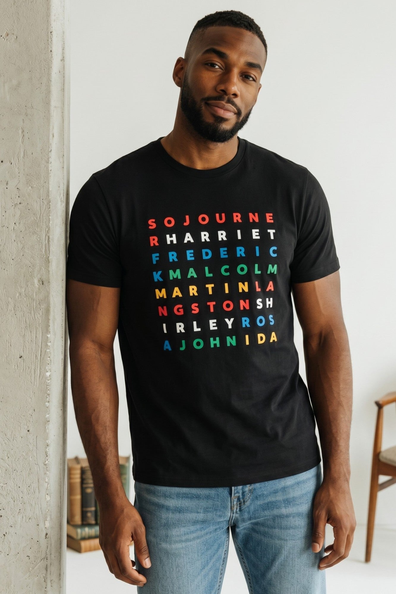 On-body traditional fit view of the black FreedomGram Juneteenth Graphic Tee, showcasing the premium 100% cotton drape, crew neck, and coverstitched sleeve details.