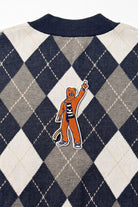 Penn State Nittany Lion mascot chenille varsity patch in brown, navy and white sewn onto back of navy, grey, and white argyle knit sweater.