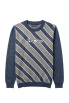Penn State University script letter varsity patch sewn onto center front chest of navy, white, and light grey repp stripe classic crew knit sweater.